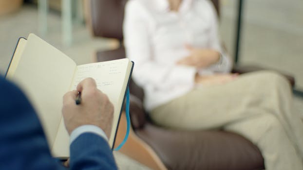 a person taking notes during a feedback session